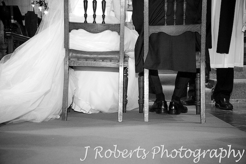 Couples feet during wedding sermon - wedding photography sydney